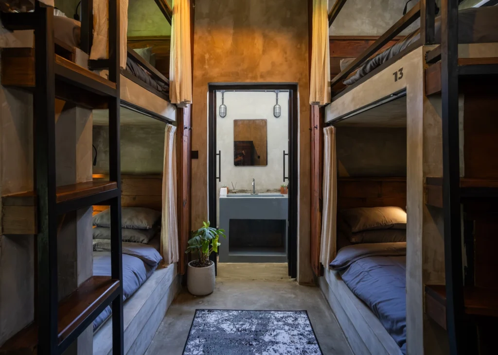 Concrete industrial bunk room with curtained berths