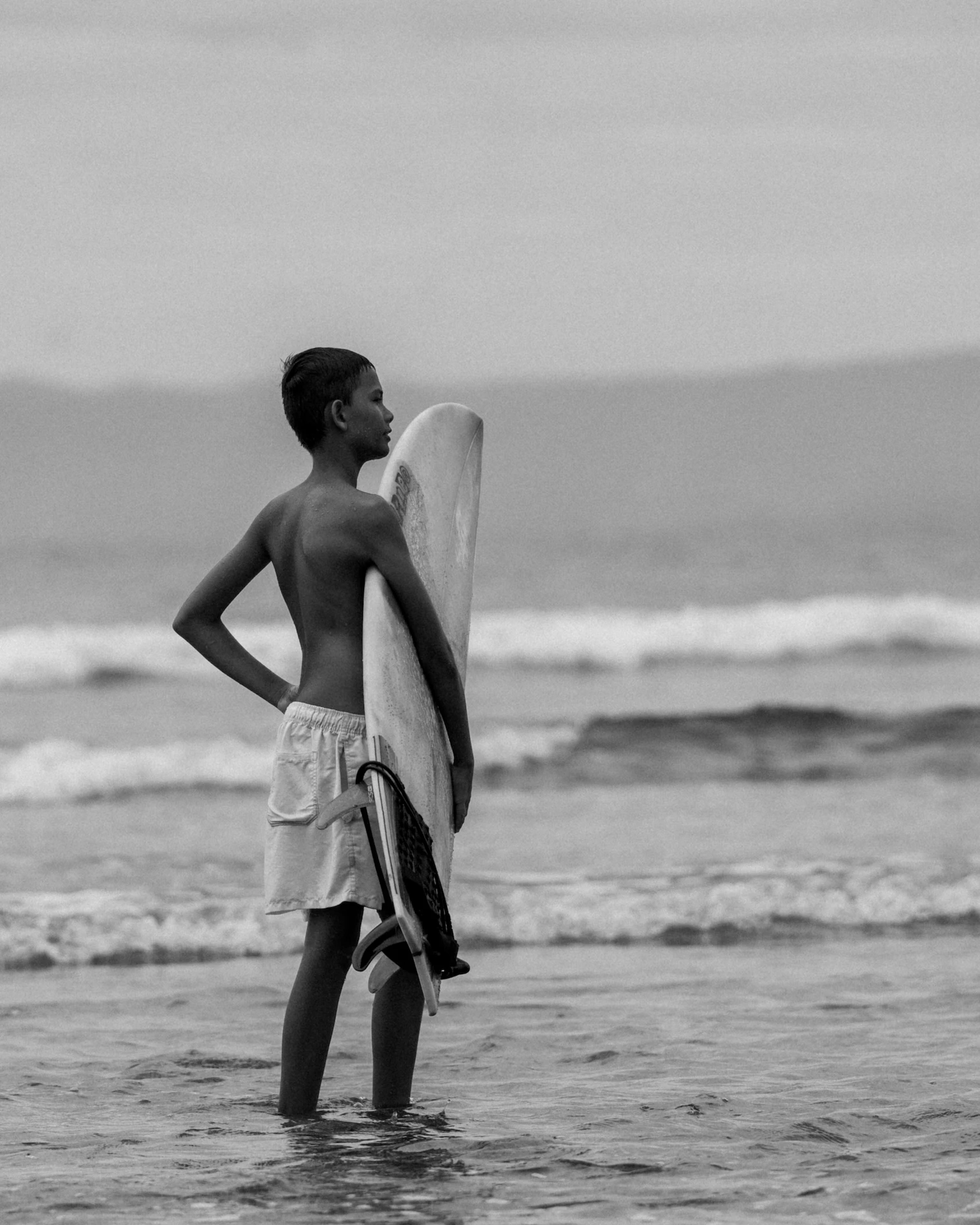 Beginner surfer catching a wave with an Iron Wave Uluwatu instructor